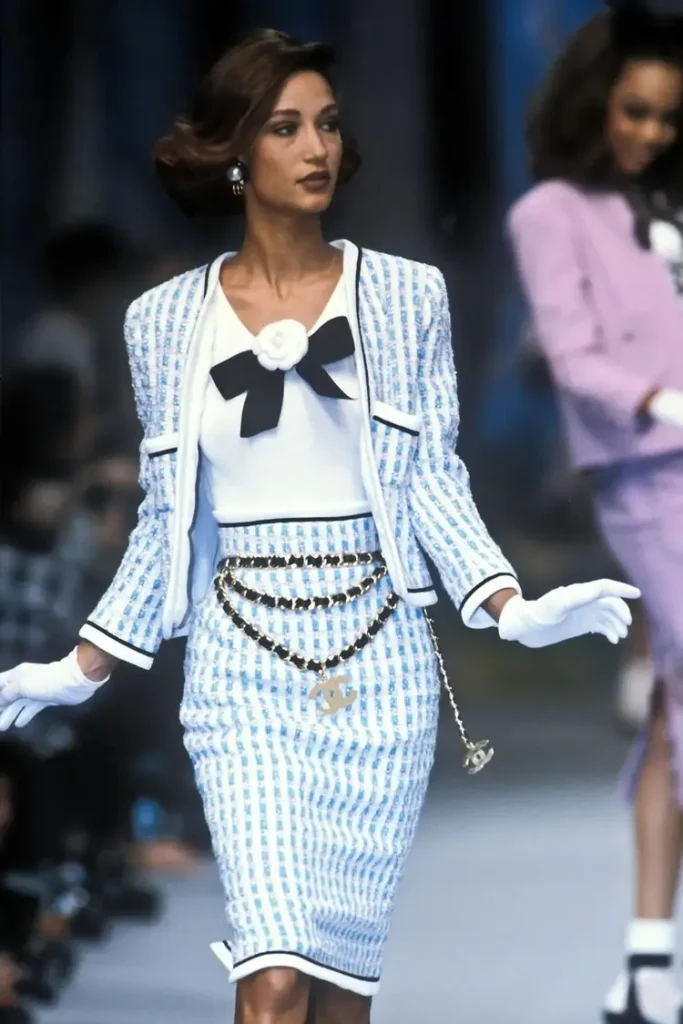 woman wearing chanel tweed jacket with the matching skirt on the runway