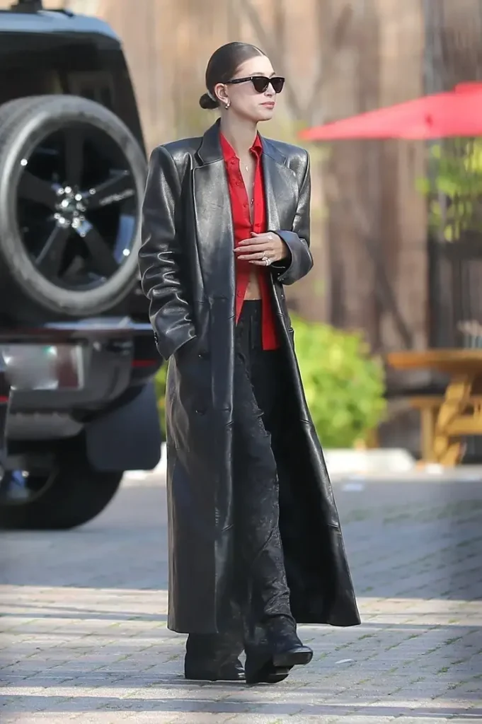 paparazzi image of hailey baldwin wearing a long leather trench coat outside