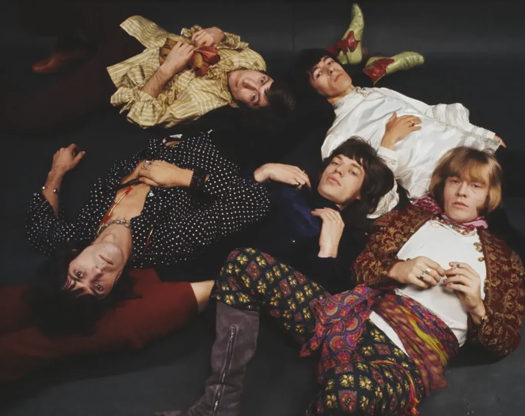 Rolling stone members laying down for a picture for their beggars banquet anniversary.