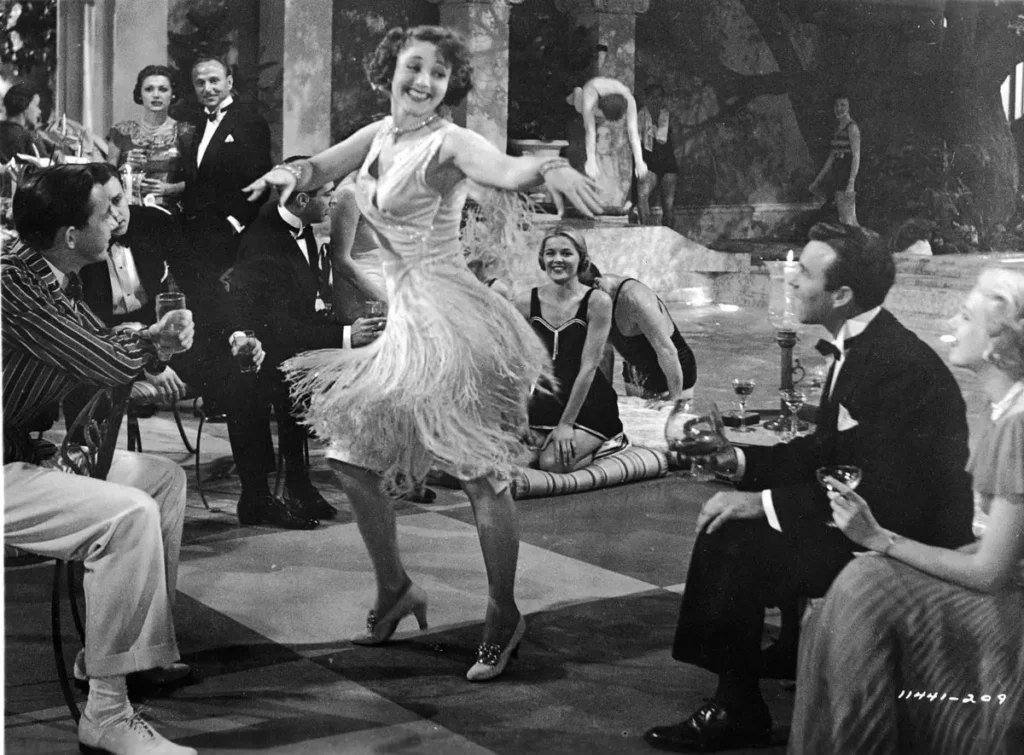 Vintage black and white image of woman wearing flapper dress at an event