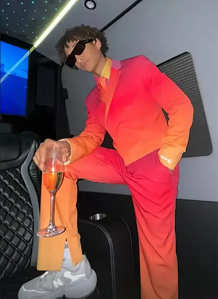 jaden wearing a matching bright peach and pink suit