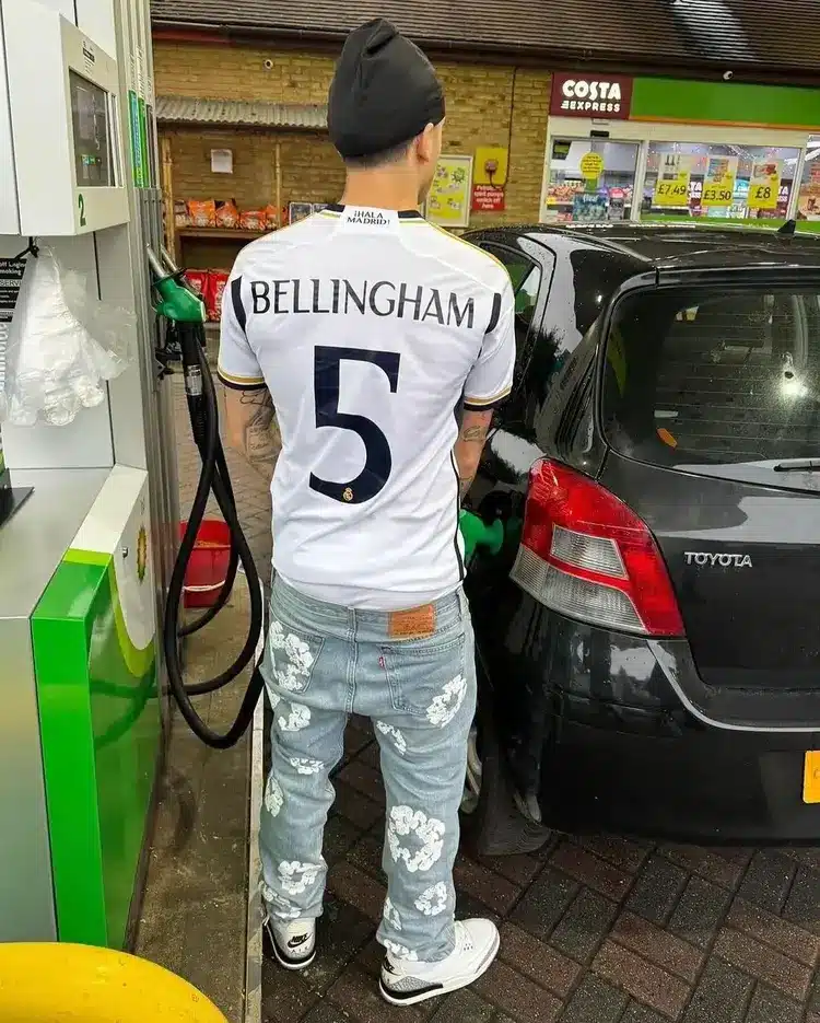 instagram image of central getting fuel in denim tears jeans with allover print