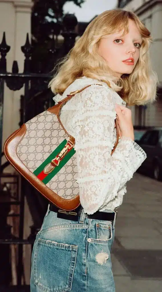 Campaign image of model carrying gucci jackie bag.