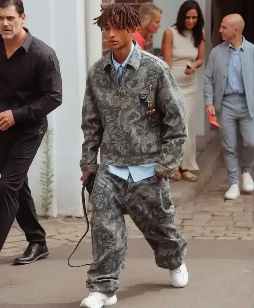 jaden wearing a light blue shirt and tie with matching cargo military pattern pants and jacket