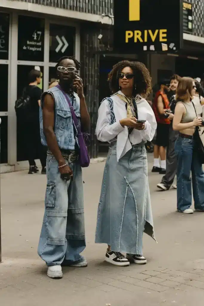 fashion week outfits with two people wearing matching denim outfits, with one wearing a blue denim skirt and the other wearing baggy denim jeans