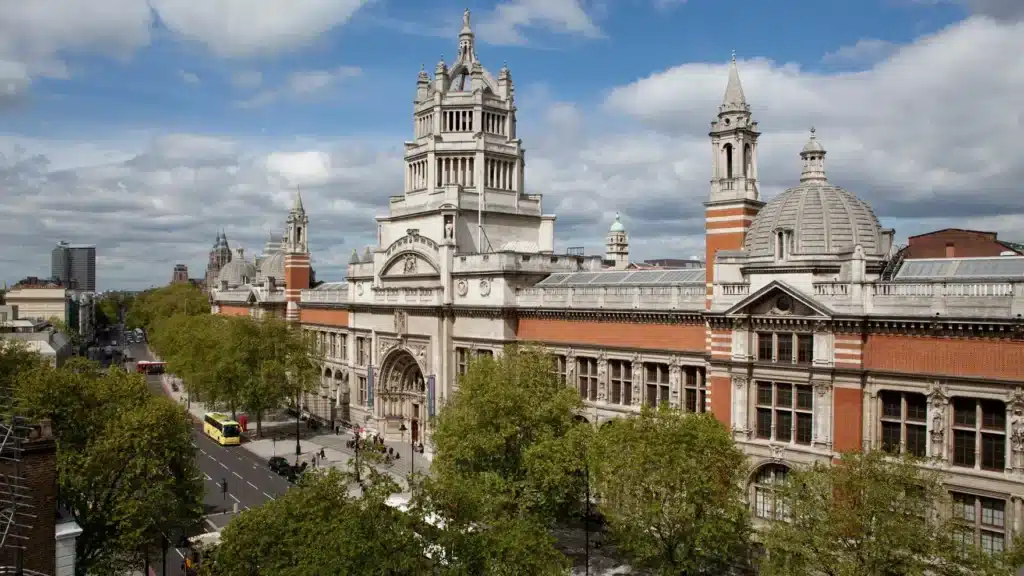The exterior view of the Victoria and Albert Museum in London, a historic building featuring grand architectural elements and intricate detailing, serving as a testament to the museum's dedication to art and design.