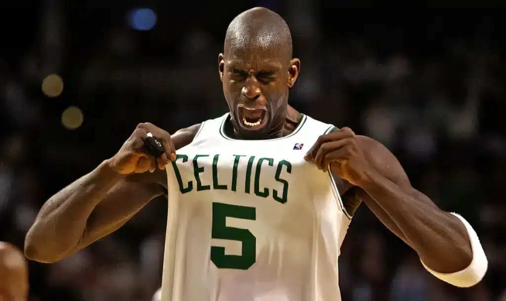 Kevin Garnett on the court celebrating and pulling on his jersey