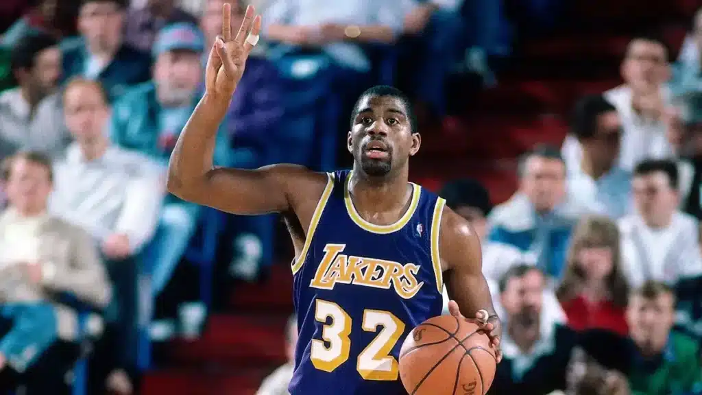 Magic Johnson playing for the lakers wearing their iconic purple and gold