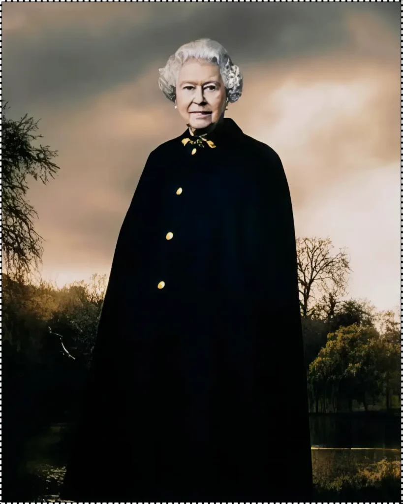 A majestic portrait by Annie Leibovitz of Queen Elizabeth II standing outdoors, wearing a dark cape with gold buttons, set against a moody sky and a backdrop of trees.