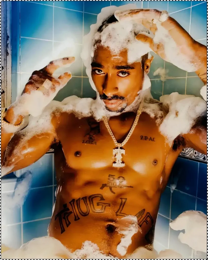 A vivid portrait by David LaChapelle of Tupac Shakur relaxing in a bathtub filled with bubbles, showcasing his tattoos and wearing a gold chain, with a serious expression.