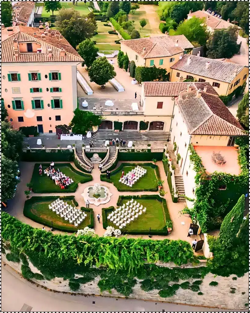 Aerial view of Il Borro Estate in Tuscany, owned by the Ferragamo family, featuring historic architecture and manicured gardens.