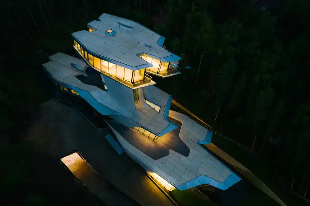 Aerial view of Naomi Campbell's futuristic house in Moscow, featuring striking modern architecture illuminated at night.